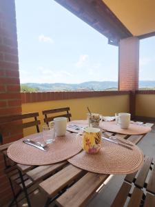 a table with two chairs and two cups on it at La casa del sole in Langhirano