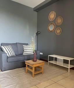 a living room with a blue couch and a table at La casa del sole in Langhirano