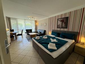 a bedroom with a bed and a living room at Schloss Kirchham Appartement - & Wellnessanlage in Kirchham