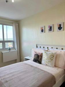 a bedroom with a large bed and a window at Seawind Condo 2 BR Near Airport and Facing Samal in Davao City