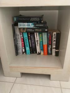 a book shelf filled with lots of books at Pondok Sembilan in Jimbaran