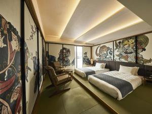 a bedroom with two beds and paintings on the walls at Asakusa View Hotel Annex Rokku in Tokyo