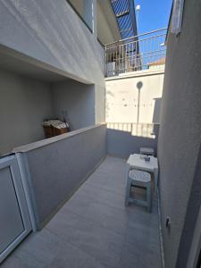 a small balcony with a table and a bench at Apartman Turkovic in Herceg-Novi +3 photos
