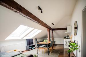 a room with a dining table and a skylight at Apartment an der Lahn am Katzenturm - 3 Betten in Limburg an der Lahn
