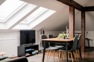 a dining room with a table and chairs at Apartment an der Lahn am Katzenturm - 3 Betten in Limburg an der Lahn