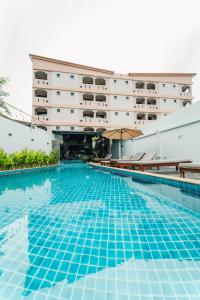 an empty swimming pool in front of a hotel at Saiyuan Residence Phuket in Rawai Beach