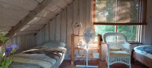 a bedroom with a bed and a chair in a room at Kenni Holiday House in Kenni
