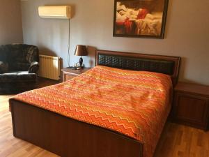 a bedroom with a bed with an orange comforter at Buzovna Villa in Baku +21 photos