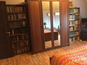 a room with two bookshelves and a mirror at Buzovna Villa in Baku