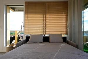 a large bed in a room with a large window at Sublime Appart Vue mer Piscine Clim in La Grande-Motte +39 photos