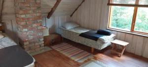 a small room with a bed and a brick wall at Kenni Holiday House in Kenni +12 photos