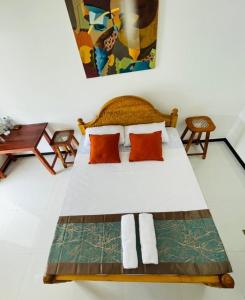 Postel nebo postele na pokoji v ubytování Ratnam Hotel Jaffna