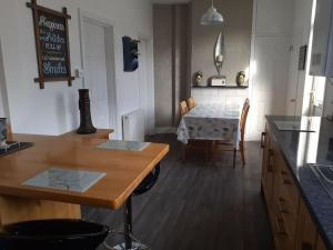 a kitchen with a table and a dining room at Well appointed terraced property in Kent