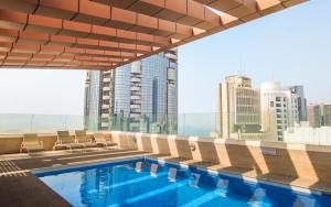 a swimming pool with a view of the city at Royal Home in Abu Dhabi