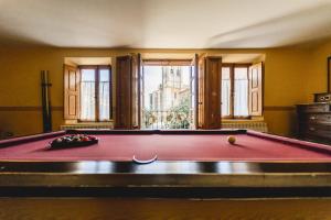 a red pool table in a room with a window at Abánades in Melgar de Fernamental