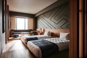 Postel nebo postele na pokoji v ubytování Asakusa View Hotel Annex Rokku + 37 fotografií