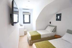 Ένα ή περισσότερα κρεβάτια σε δωμάτιο στο La Maltese Boutique Paros