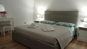 a bedroom with a bed with two towels on it at Casa Mirta in Mandello del Lario