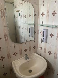 a bathroom with a sink and a mirror at Baga Beach Palms in Baga +24 photos