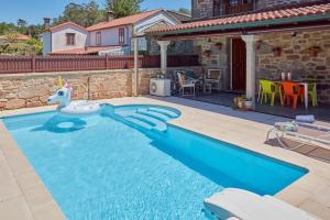 a swimming pool in a yard with a house at Casa Condomiña in Amés
