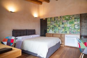 a bedroom with a bed and a table and a desk at DONNAPAOLA MODERN FARM in Altamura