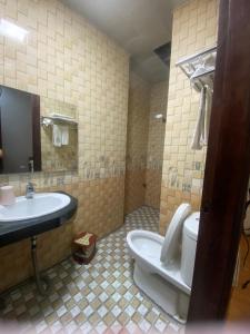 a bathroom with a sink and a toilet and a sink at Khách sạn Bảo Sơn 1 in Lao Cai