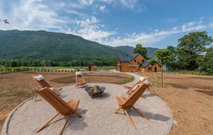 a group of chairs sitting around a fire pit at Stunning Home In Rizvanusa With Sauna in Rizvanuša +38 photos