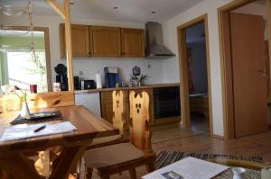 a kitchen with wooden cabinets and a wooden table at Haus-Panoramablick in Königstein an der Elbe +7 photos
