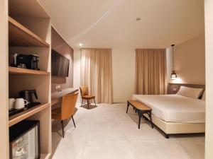 a hotel room with a bed and a tv at Hotel Lauri in Macerata