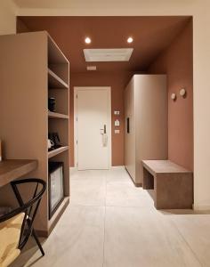 a hallway with a living room with a couch and a tv at Hotel Lauri in Macerata