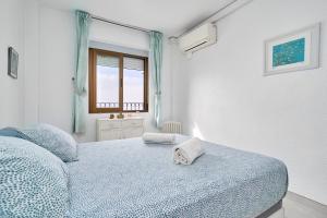 Un dormitorio con una cama azul y una ventana. en Atalaya, en Almuñécar 23 fotos más