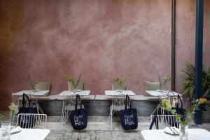 a row of tables and chairs with bags on them at Hotel Brummell in Barcelona