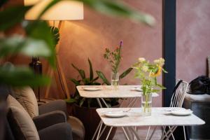 two tables in a restaurant with vases of flowers on them at Hotel Brummell in Barcelona