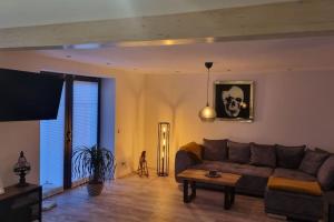 ein Wohnzimmer mit Sofa und Tisch in der Unterkunft Cottbus Merzdorf Bauernhaus Ferienhaus in Cottbus