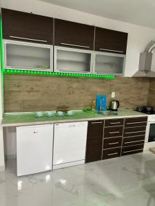 a kitchen with white appliances and brown cabinets at Apartments Ljiljanic in Budva