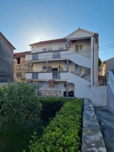 a building with balconies on the side of it at Apartmani Bada in Pakoštane