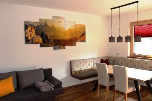 a living room with a couch and a dining room table at Apart Sunny Side in Ramsau im Zillertal