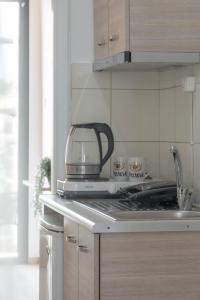 a toaster sitting on top of a stove in a kitchen at Hotel12 in Leptokarya +67 photos