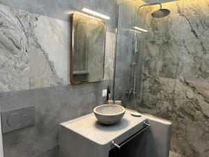 a bathroom with a bowl sink and a shower at George Studios 2 in Kithnos