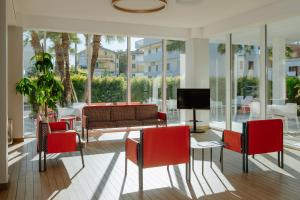 a living room with a table and chairs and a tv at Hotel Caravel in Vasto