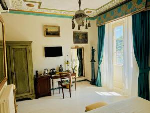 a bedroom with a desk and a television on the wall at La Casa Di Agartha in Bolsena