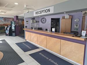 a reception area of a restaurant with a counter at Britannia Edinburgh Hotel in Edinburgh
