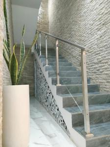 a staircase in a building with a potted plant at Villa Emas Mulia Uluwatu Standard 5 in Uluwatu +8 photos