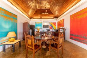 a dining room with a table and chairs at Villa Naina, Marari beach in Alleppey