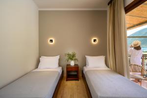 Postel nebo postele na pokoji v ubytování Elisso Hotel