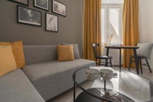 a living room with a couch and a glass table at HARBOR APARTMENTS - Zabrska in Katowice