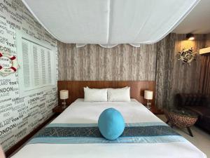 a bedroom with a bed with a blue ball on it at Benyada Lodge - Surin Beach in Surin Beach