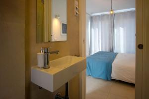 En eller flere senge i et værelse på Townhouse Bombarda