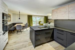 a kitchen with a table and a dining room at Das Förstereck in Viehhofen