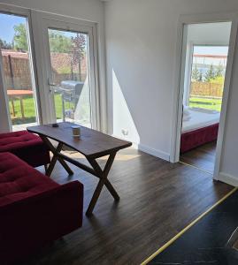 a living room with a coffee table and a couch at Domek nad jeziorem in Kruklanki +21 photos